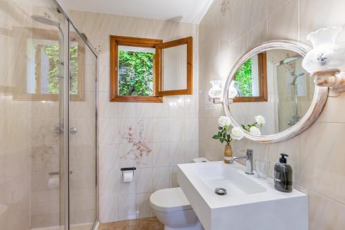 a bathroom with a toilet and a sink and a shower at Can Sito in Cala Tuent