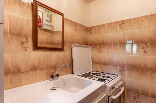 a small kitchen with a sink and a stove at Appartement de charme in Ruoms