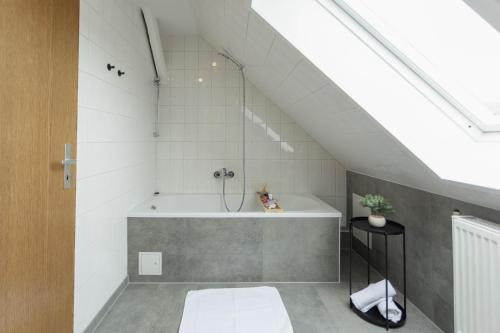a bathroom with a shower and a bath tub at Cityloft für Stilvolle in Dessau