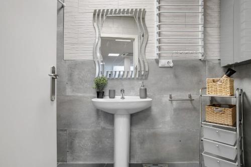 a bathroom with a sink and a mirror at Loft Los Olivos in Algar