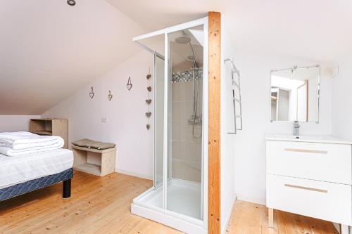 a bathroom with a shower and a bed in a room at Maison Boyardville Piscine in Saint-Georges-dʼOléron