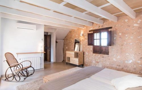 a bedroom with a bed and a chair in a room at Son Sec Nou in El Palmer
