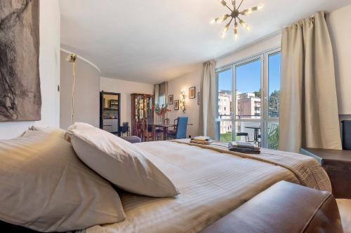 a bedroom with a large bed with a large window at Lake Como Style Home in Lecco