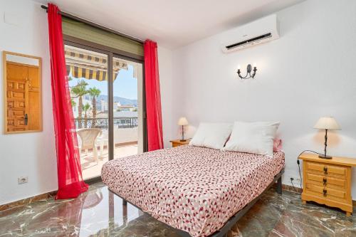 a bedroom with a bed and a window at Lily in Almuñécar