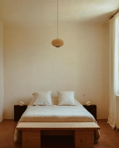 a bedroom with a bed and a pendant light at CHB - Château de la Haute Borde in Rilly-sur-Loire