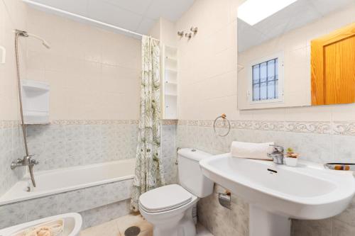 a white bathroom with a sink and a toilet at Good Atmosphere in Orihuela