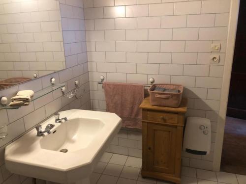 a white bathroom with a sink and a mirror at La Passerelle de la Doller in Reiningue