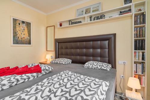 a bedroom with two beds and a book shelf at Casa Cox Laguna Beach Torrox Costa in Torrox Costa