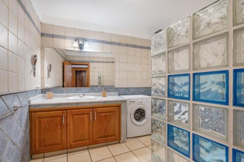 a bathroom with a sink and a washing machine at El Ciruelo in Valverde