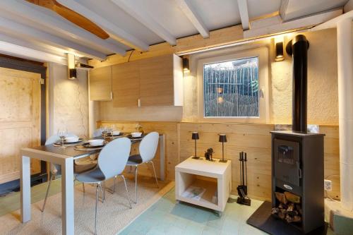 a kitchen with a table and a wood stove at Haus am Gardasee mit Seeblick in Raffa