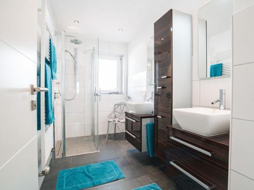 a white bathroom with a sink and a shower at Ferienwohnung 12 Kirschen in Durbach