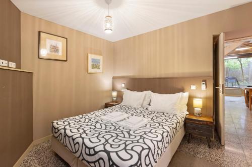 a bedroom with a bed with a black and white comforter at Orange Apartments A in Porto