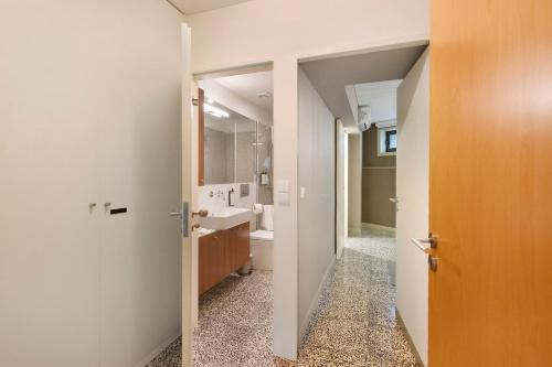 a bathroom with a sink and a toilet and a mirror at Orange Apartments A in Porto