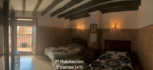 a bedroom with two beds in a room with a window at Casa Bohemio - Tabarca in Tabarca