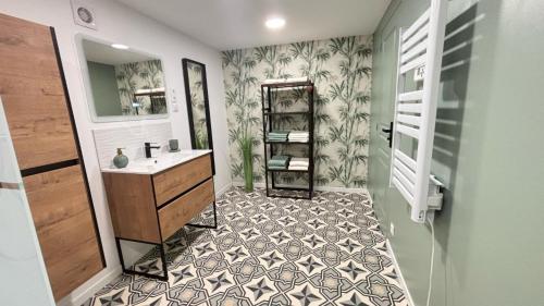 a bathroom with a sink and a mirror at Sous Le Tilleul - 3 personnes in Valréas