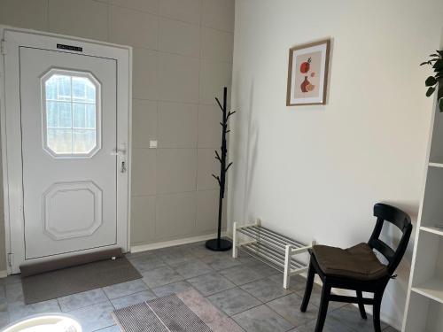 a room with a white door and a chair at Am Conradhof 2 in Goch