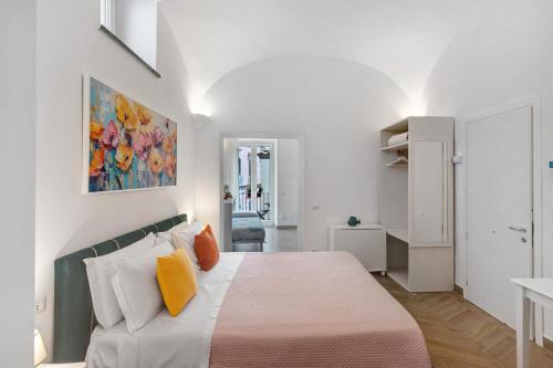 a bedroom with a bed with orange and white pillows at Lubrense Signature Suites in Massa Lubrense