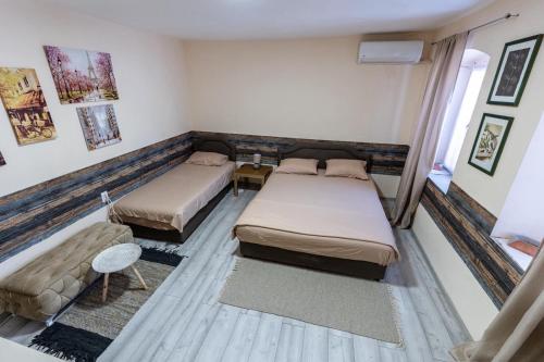 a room with two beds and a couch at Old street 2 in Podgorica