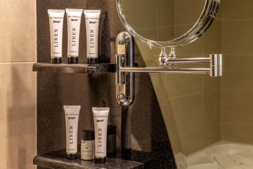 a group of fourental products on a shelf in a bathroom at Canal Court in Newry