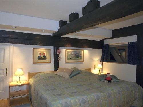 a bedroom with a bed with a doll sitting on it at Historisches Haus Uhlenhorst in Trebel