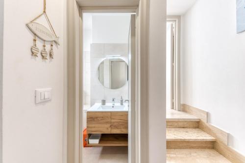 a bathroom with a sink and a mirror at Franza 2 in Torre San Giovanni Ugento