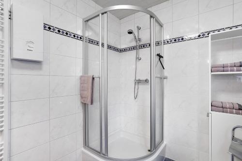 a shower with a glass door in a bathroom at Ferienwohnung Gaberle in Balve