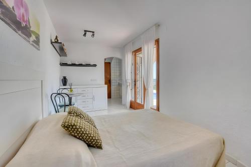 a bedroom with a bed in a white room at Villa Romantica by Easy Brava in Calonge