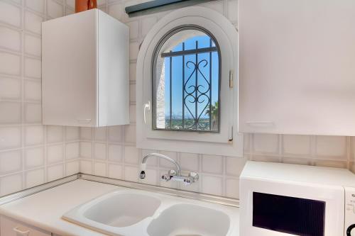 a kitchen with a sink and a window at Villa Romantica by Easy Brava in Calonge