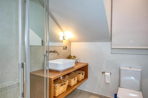 a bathroom with a sink and a shower at Casa dins el Mar en Calella in Calella de Palafrugell