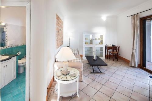 a living room with a couch and a table at Tenuta Del Poggio Antico in Ischia