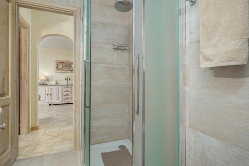 a shower with a glass door in a bathroom at Mazzini Apartment - by And Service in Golfo Aranci