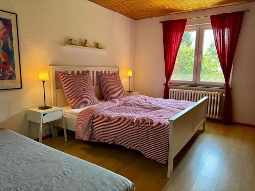 a bedroom with two beds and a window at Alpenblick-Hotzenwald in Rickenbach