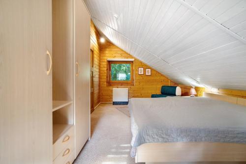 a bedroom with a bed in a wooden house at Haus Reiher in Lychen