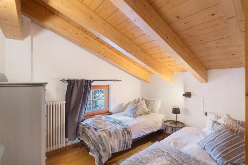 a living room with a bed and a couch at Chalet Royal in Livigno