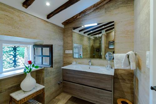 a bathroom with a sink and a mirror at Masia Mimosa Completa in Darnius