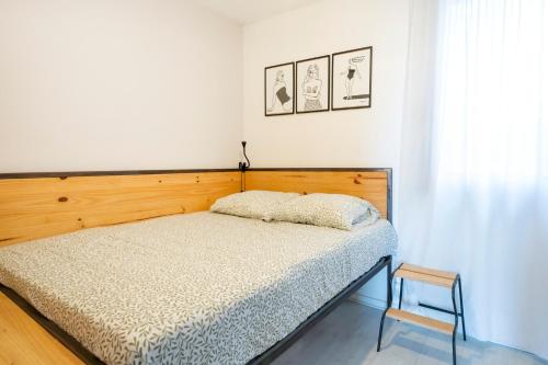 a bedroom with a bed with a wooden headboard at Appartement Vue Sur La Dune in Seignosse