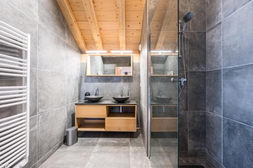 a bathroom with two sinks and a shower at Germain Ski Lodge in La Toussuire