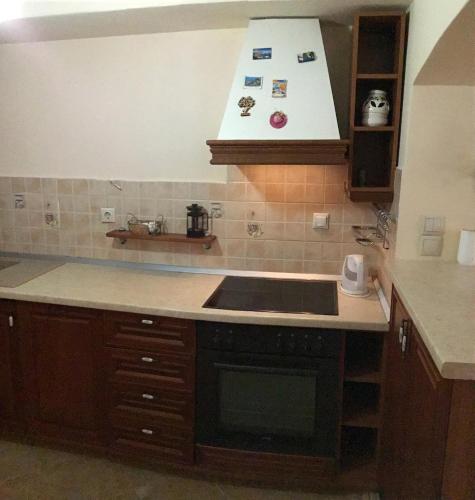 a kitchen with a sink and a stove at Emma's studio house by Kapsali beach in Kapsali
