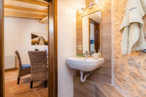 a bathroom with a sink and a mirror and a table at Apartment Adults Only - Mallorca in Manacor