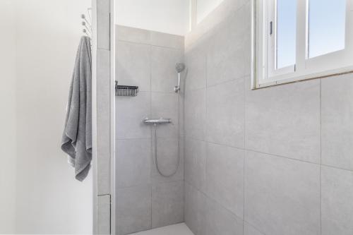 a bathroom with a shower with a glass door at El encanto de Ronda in Ronda