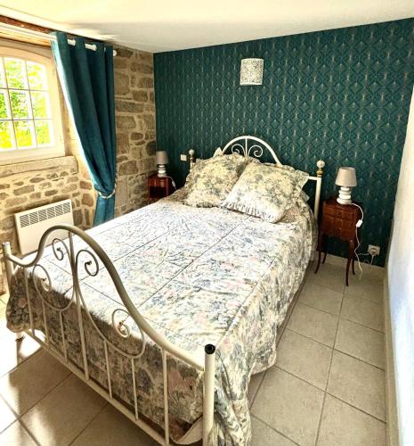 a bedroom with a bed and a green wall at Gite rural La Madeleine in Saint-Mathurin-Léobazel