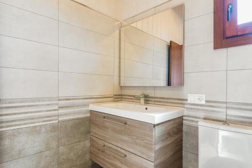 a bathroom with a sink and a mirror at Casa Hefestión in Conil de la Frontera