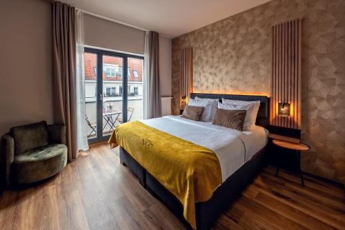 a hotel room with a bed and a chair at Residency NO7 in Berlin