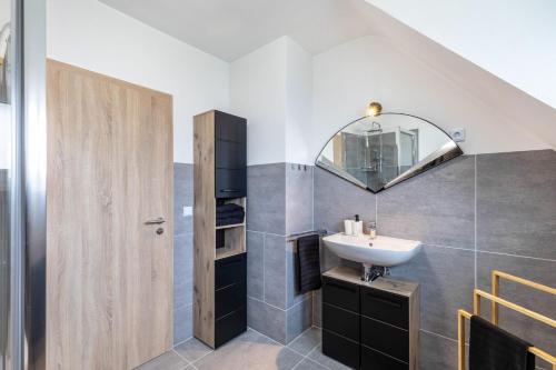 a bathroom with a sink and a mirror at Ferienhaus Soonwald Liebe in Seesbach