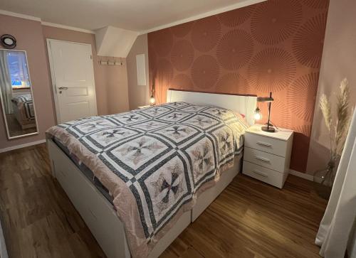 a bedroom with a bed with a quilt on it at Schmidnickels Hof in Schwarzerden