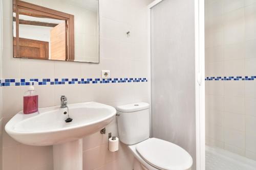 a bathroom with a sink and a toilet and a mirror at Estudio Quorum, centro de Nerja in Nerja