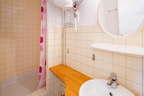 a bathroom with a sink and a shower at Les Mimosas - Appartement 12 in Cazaubon