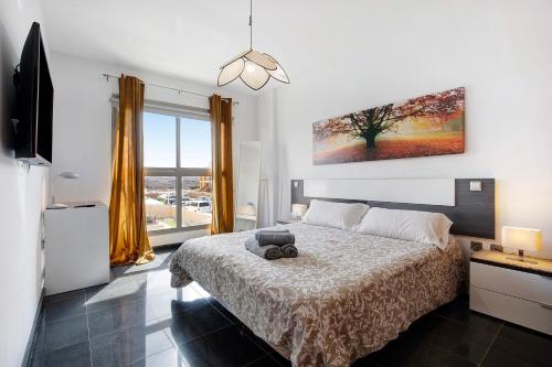 a bedroom with a bed with a teddy bear on it at Marfolin 22 in El Cotillo