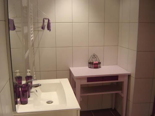 a white bathroom with a sink and a shower at Gîte Ancien Relais De Poste in Les Rousses