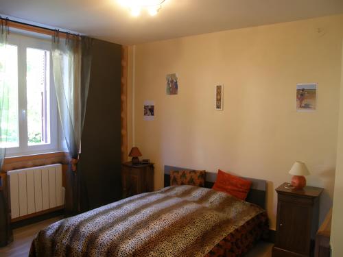 a bedroom with a bed and a window at Gîte Ancien Relais De Poste in Les Rousses